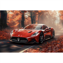 Lade das Bild in den Galerie-Viewer, Aluminiumbild gebürstet Roter Sportwagen fährt durch herbstlichen Wald Querformat
