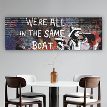 Lade das Bild in den Galerie-Viewer, Aluminiumbild gebürstet Banksy - We&#39;re all in the same boat Panorama
